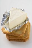 Processed cheese in foil on crackers