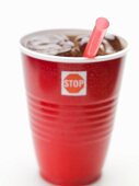 Cola with ice cubes and straw in plastic cup