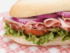 Ham, salami, onion, tomato and lettuce sandwich