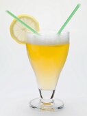 Glass of shandy with slice of lemon and straws (UK)