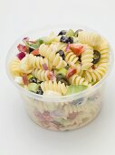 Pasta and vegetable salad in plastic container