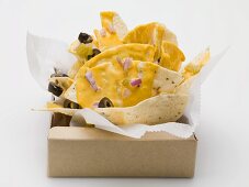 Tortilla chips with cheese, olives and onions to take away
