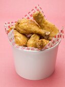 Breaded chicken pieces to take away (red background)