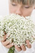 Woman holding a bouquet of gypsophila