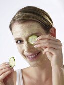 Woman with cucumber face mask