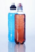 Two energy drinks (red and blue) in plastic bottles