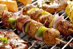 Meat, onion and pepper kebabs on barbecue