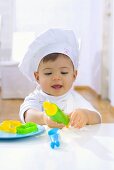 Little girl with rolling pin and biscuit cutters