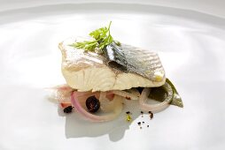 Trout fillet poached in wine with onion
