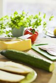 Cheese, vegetables, sausage and herbs in the kitchen