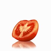 Half a tomato with a white background and reflection