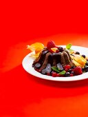 Chocolate pudding with fruit and chocolate sauce
