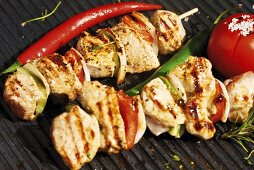 Meat kebabs and vegetables on barbecue rack