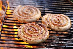 Coiled sausages on barbecue rack