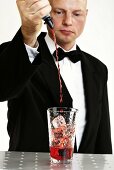 Barkeeper pouring liquid into glass