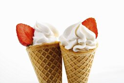 Soft ice cream with strawberries in waffle cone