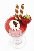 Strawberry milkshake with cream and wafer rolls