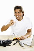 Man at desk drinking water, close-up