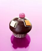 Muffin with chocolate icing and liquorice allsorts
