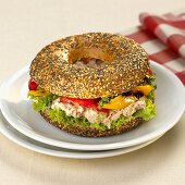 Poppy and sesame seed bagel filled with tuna salad