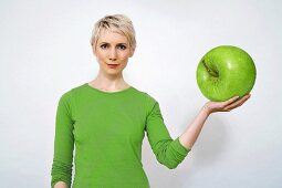 Woman holding apple, close-up