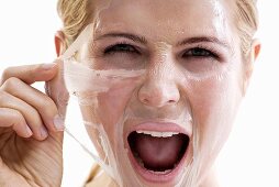 Woman removing face mask