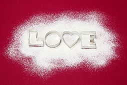 Biscuits cutters for 'LOVE' biscuits on icing sugar