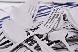 Spoons and forks on tea towel