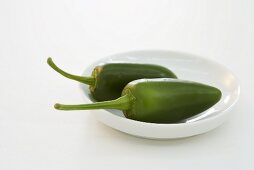 Two green chillies on plate