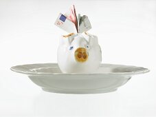 Piggy bank with bank notes in a dish