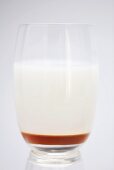 A glass of whey with honey