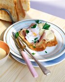 Toast with ham and poached egg on plate