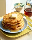 Buttermilk pancakes with maple syrup on plate