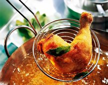 Close-up of fried chicken leg on skimmer