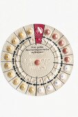 Round pill packet with one pill missing on white background