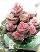 Stack of muffins with sour cherries and candied rose petals on cake stand
