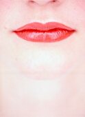 Extreme close-up of woman wearing red lipstick