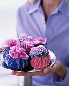 Eggs wrapped in velvet and decorated with flowers on silver platter