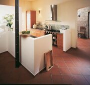 Open kitchen separated by white balustrade with modern terracotta tiles