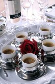 Espresso coffee in silver cups served on silver platter