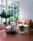 View of living room with large window and furniture in colonial style