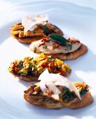 Close-up of crostini topped with chanterelle mushrooms, mashed beans and ratatouille
