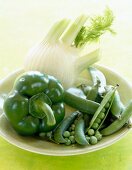 Close-up of green pepper, fennel, peas on a plate