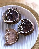 Half moon face shaped chocolate cookies on plate for Christmas