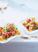 Calamari with vegetables served on plates