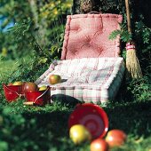 Mattresses pillows with fruits in small bucket on grass