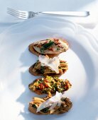 Crostinis with chanterelle mushrooms, bean puree and ratatouille on plate