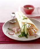 Radish and rocket wrap on plate with a fork