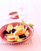 Couscous with marinated fruit in ceramic bowl