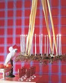 Metal candlesticks with candles and multiflora berries